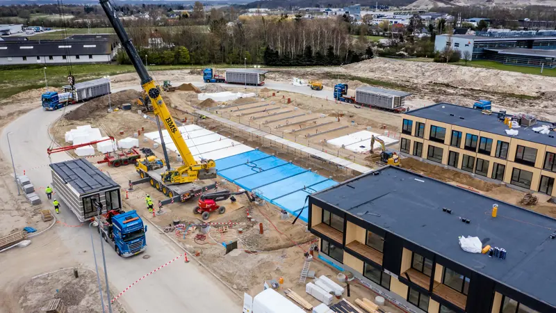 Kranmontage af moduler ved Ibihaven i Slagelse. Med lastbiler holdende i kø med moduler